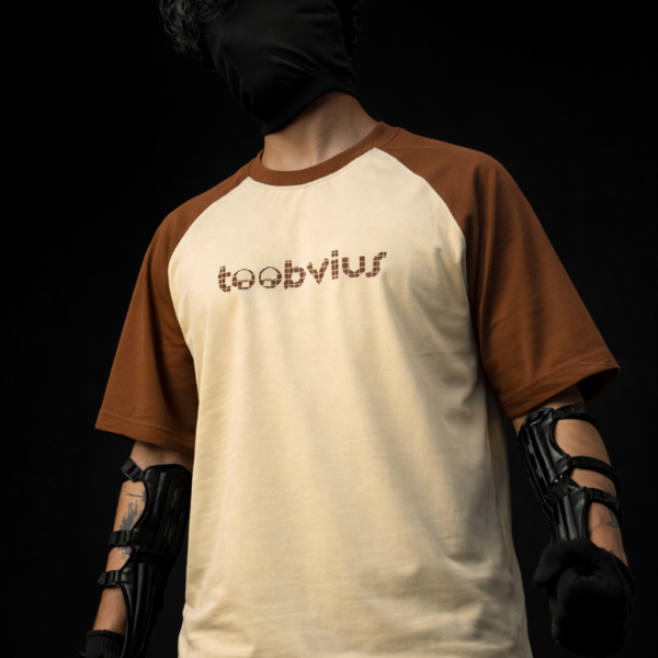 Noise Meets Structured Equalizer reglan oversized t-shirt front view with beat-inspired equalizer grid logo in brown on beige body
