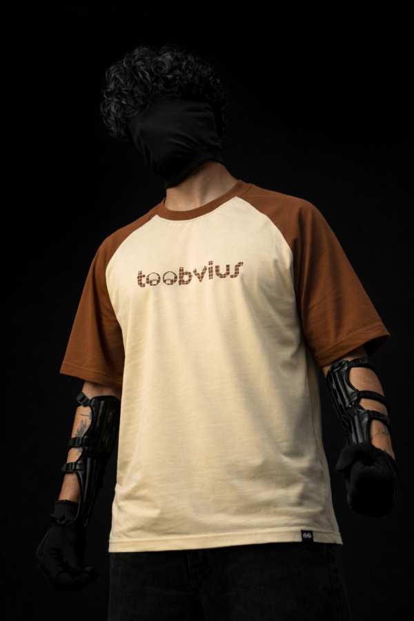 Noise Meets Structured Equalizer reglan oversized t-shirt front view with beat-inspired equalizer grid logo in brown on beige body