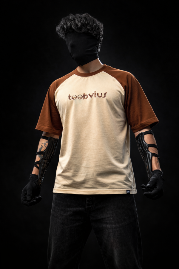 Noise Meets Structured Equalizer reglan oversized t-shirt front view with beat-inspired equalizer grid logo in brown on beige body