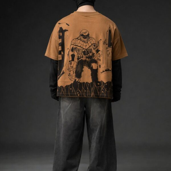 Brown oversized t-shirt back view with bold black superhero graphic design