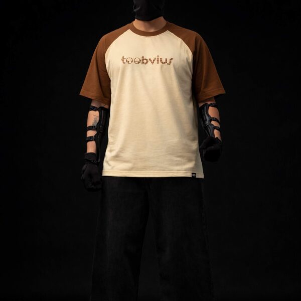 Noise Meets Structured Equalizer reglan oversized t-shirt front view with beat-inspired equalizer grid logo in brown on beige body