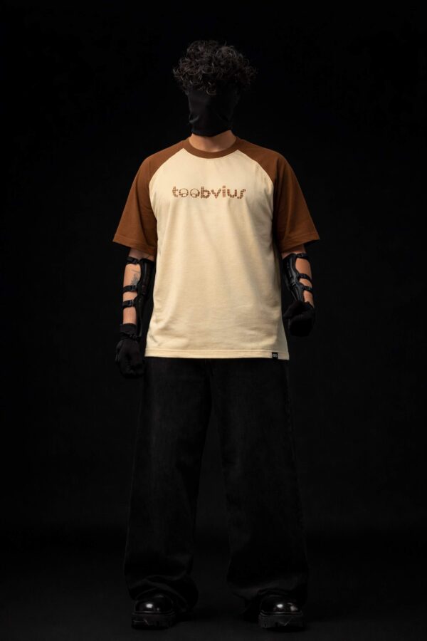 Noise Meets Structured Equalizer reglan oversized t-shirt front view with beat-inspired equalizer grid logo in brown on beige body
