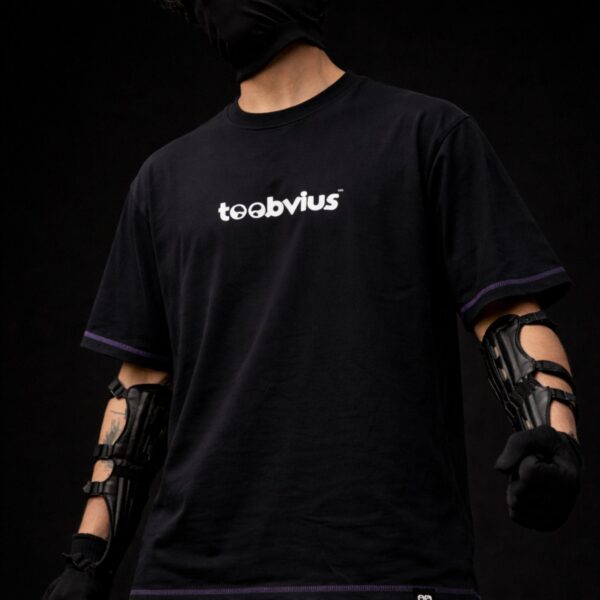 Black oversized t-shirt with Toobvius logo print on front, purple stitch detailing, streetwear fashion India